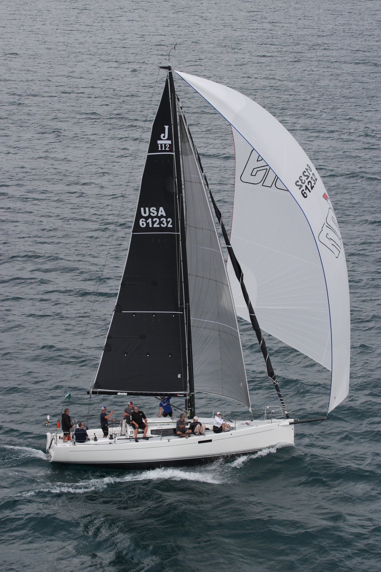 Elevation, a J/112E, sailing with a white asymmetric spinnaker and a spinnaker staysail set underneath it